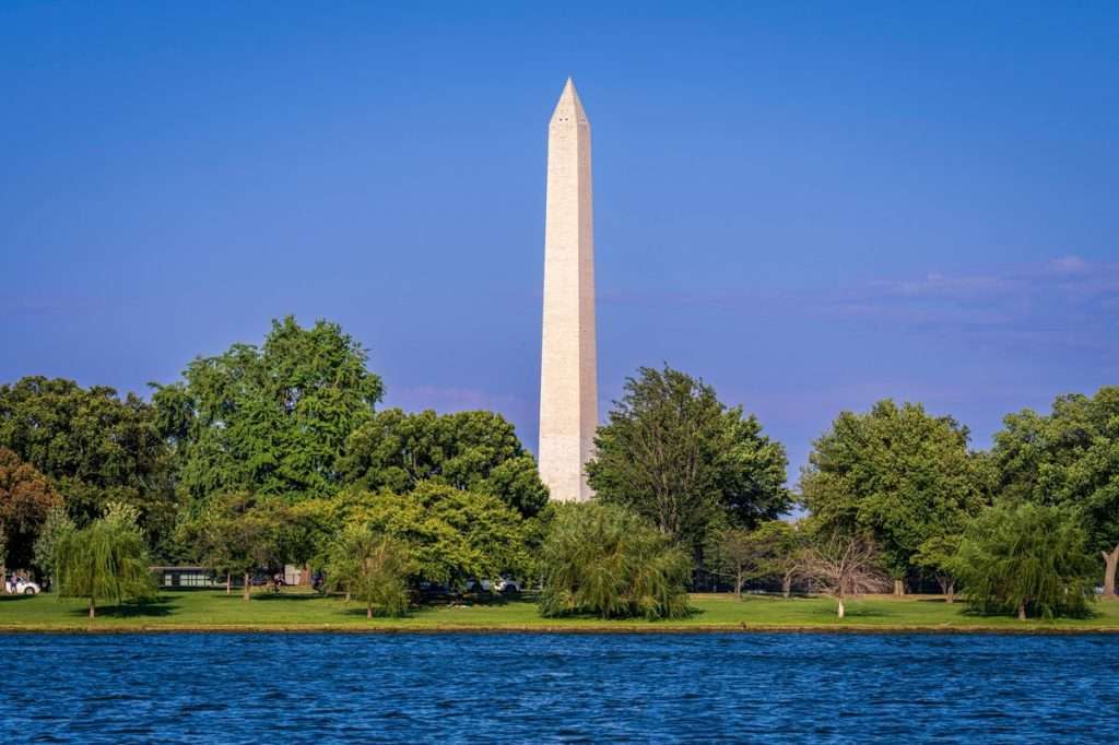 washington monument on a sunny day with clear skies grass marble restoration