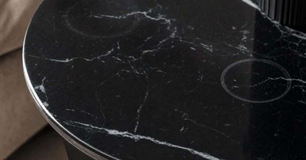 Ring-shaped etch marks on polished black marble table