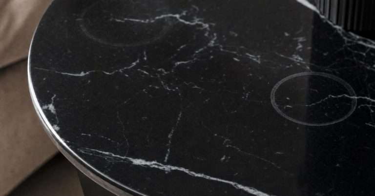 Ring-shaped etch marks on polished black marble table